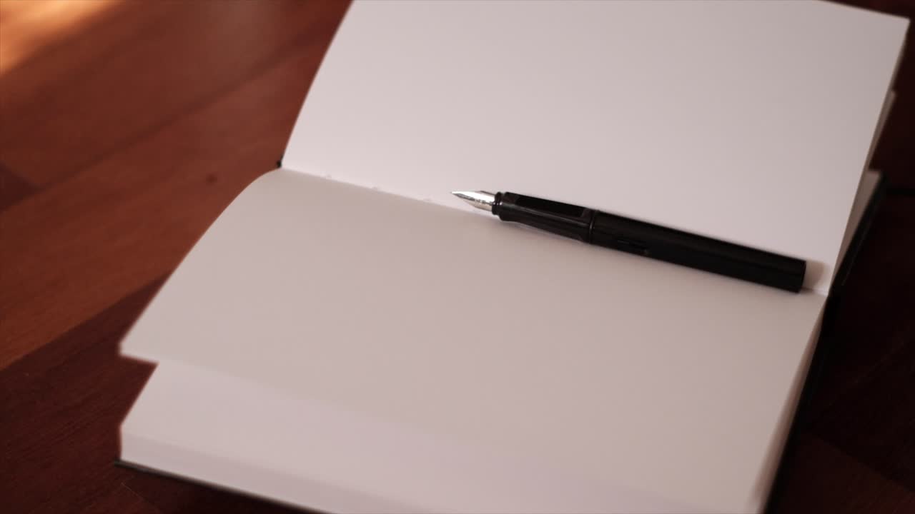 Artistic Writing Tools: Notebook and Fountain Pen in Mesmerizing Slow Motion