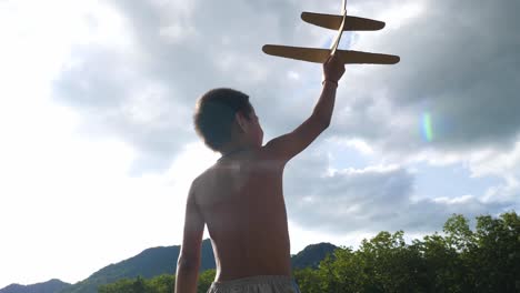 child playing with a toy airplane