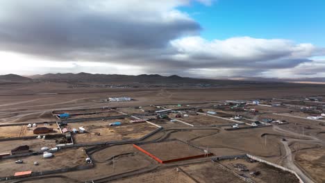 Cinematic-aerial-view-of-a-Mongolian-town-in-the-endless-steppe-surrounding-Ulaanbaatar,-the-capital-of-Mongolia