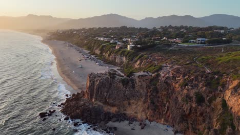 golden hour flyover: pt dume cliff at malibu beach sand in california