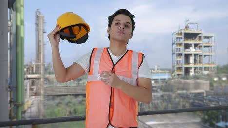 indian construction labour removing the helmet