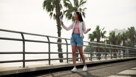 woman vlogging on a beach road