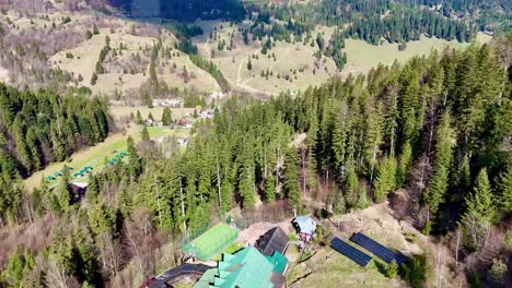 Drone-flight-above-an-isolated-lodge-in-the-woods-on-a-sunny-day