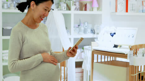 pregnant woman using mobile phone at home 4k