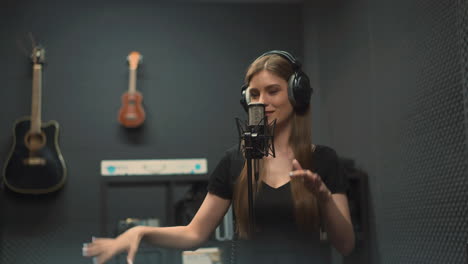 Blonde-vocalist-sings-song-with-microphone-against-guitars