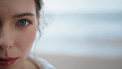 closeup calm girl face with beautiful green eyes looking camera vertically.