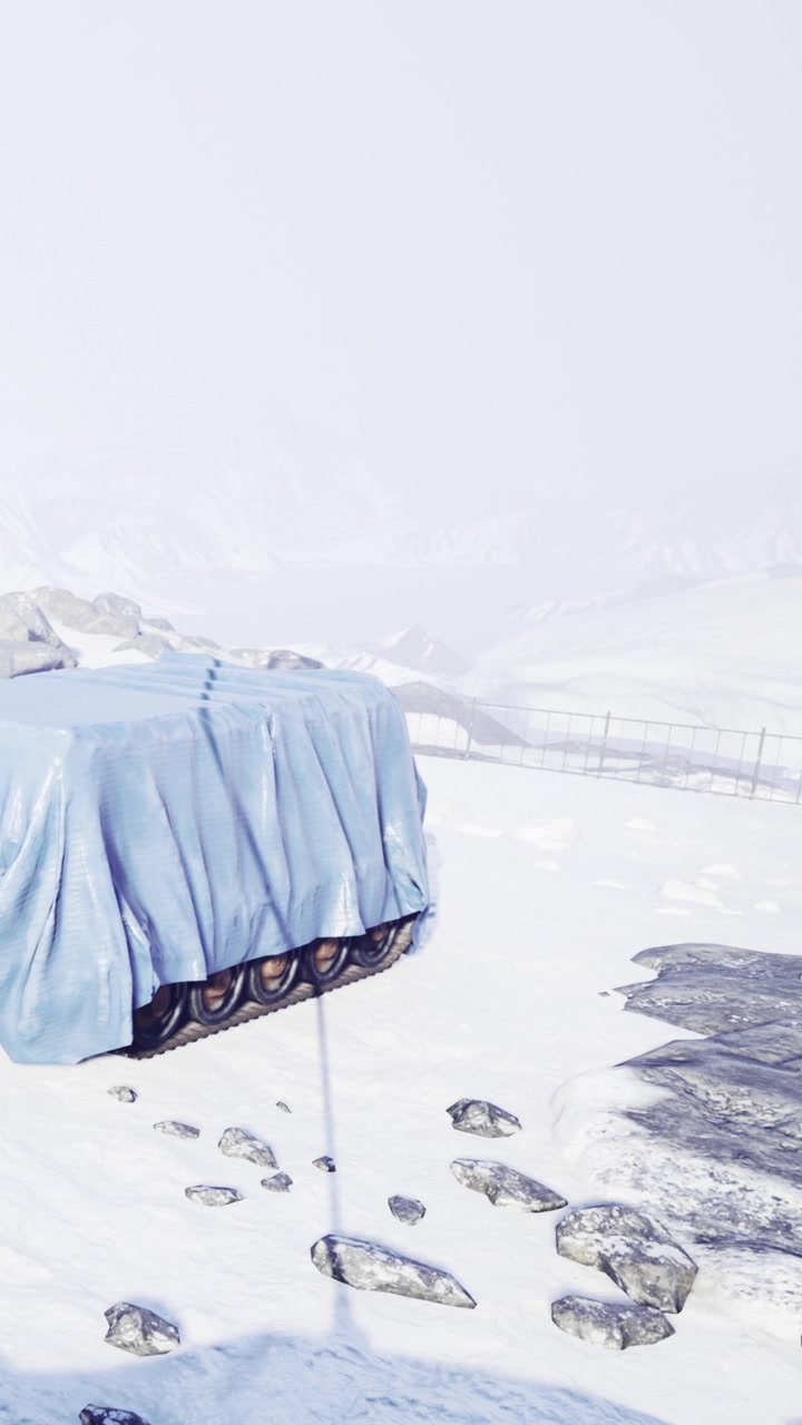Vehicle covered with tarp on snowy landscape near mountain range in winter