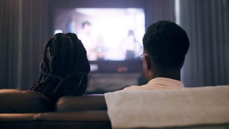 couple watching tv at home