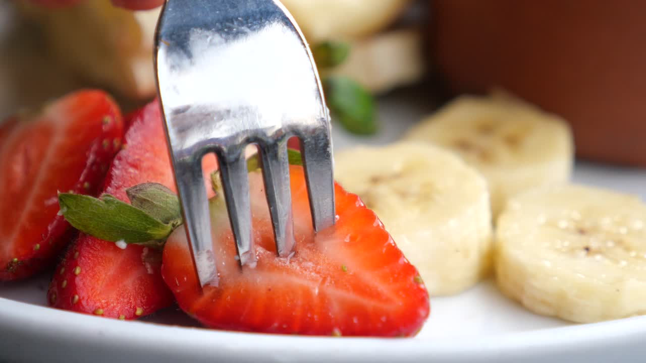 крупный план нарезанных клубники и бананов на тарелке