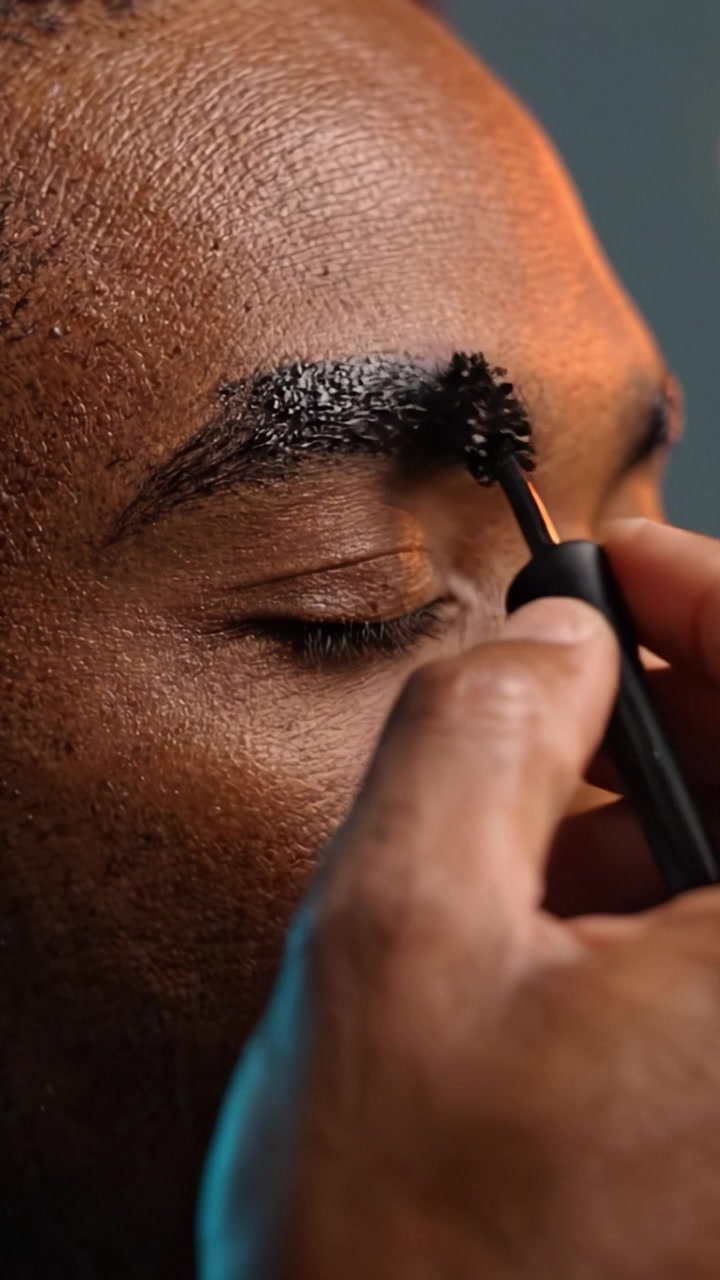 A Close-Up Journey of Eyebrow Grooming: Applying and Setting Products for a Polished Look on a Model's Face with Attention to Detail and Skin Texture