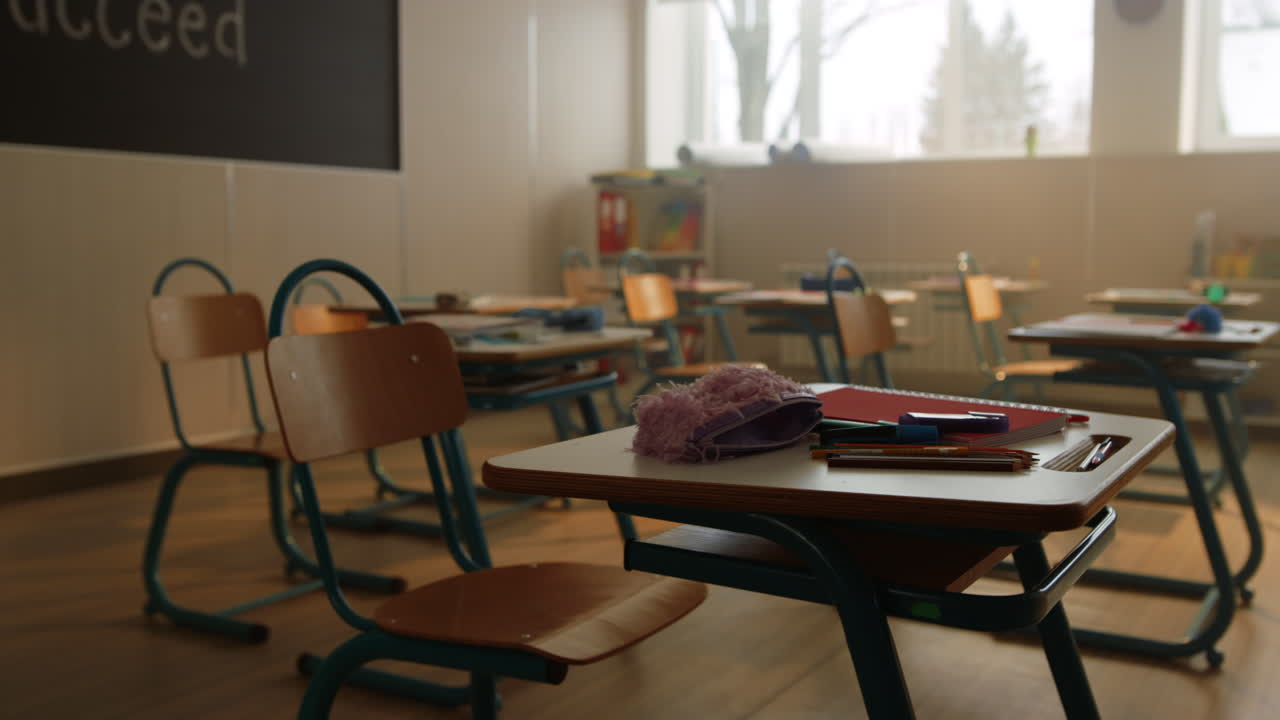 Desks and chairs in modern classroom. Interior of school room with natural light