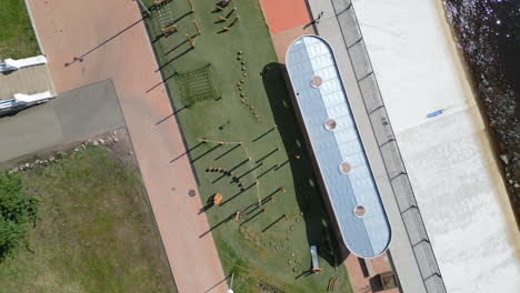 aerial view of a waterfront park with playground and cyclist