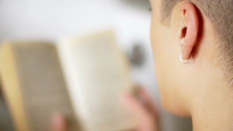 Man-reading-book-while-lying-in-bathtub-at-home-4k