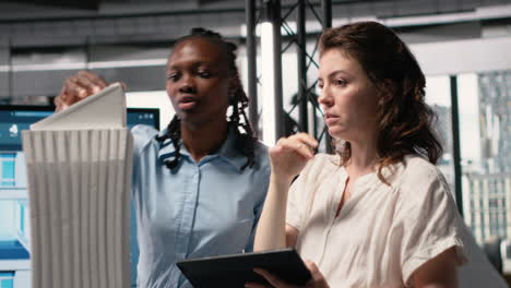 vertical video diverse colleagues review structural plans for a property investment