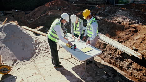 construction workers reviewing plans on site