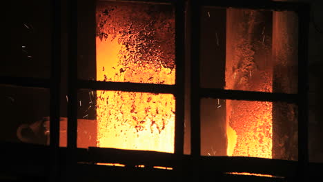 Smelting-furnace-sparks.-Hot-steel-sparks-from-industrial-furnace