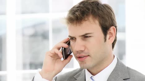 Attractive-businessman-talking-on-phone