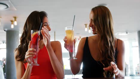 two women clinking glasses