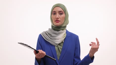 woman in hijab holding a clipboard