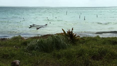 Fishing-boat-partially-submerged-ashore-in-ocean-waters,-Fanning-Island-Atoll,-Republic-of-Kiribati