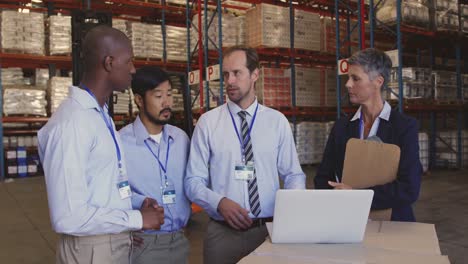 managers and staff talking in a warehouse laoding bay 4k