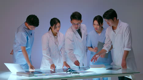 doctors nurse and team experts medical having meeting with medical staff in conference room holding radiography advising with coworker. clinic therapist talking with colleagues about disease