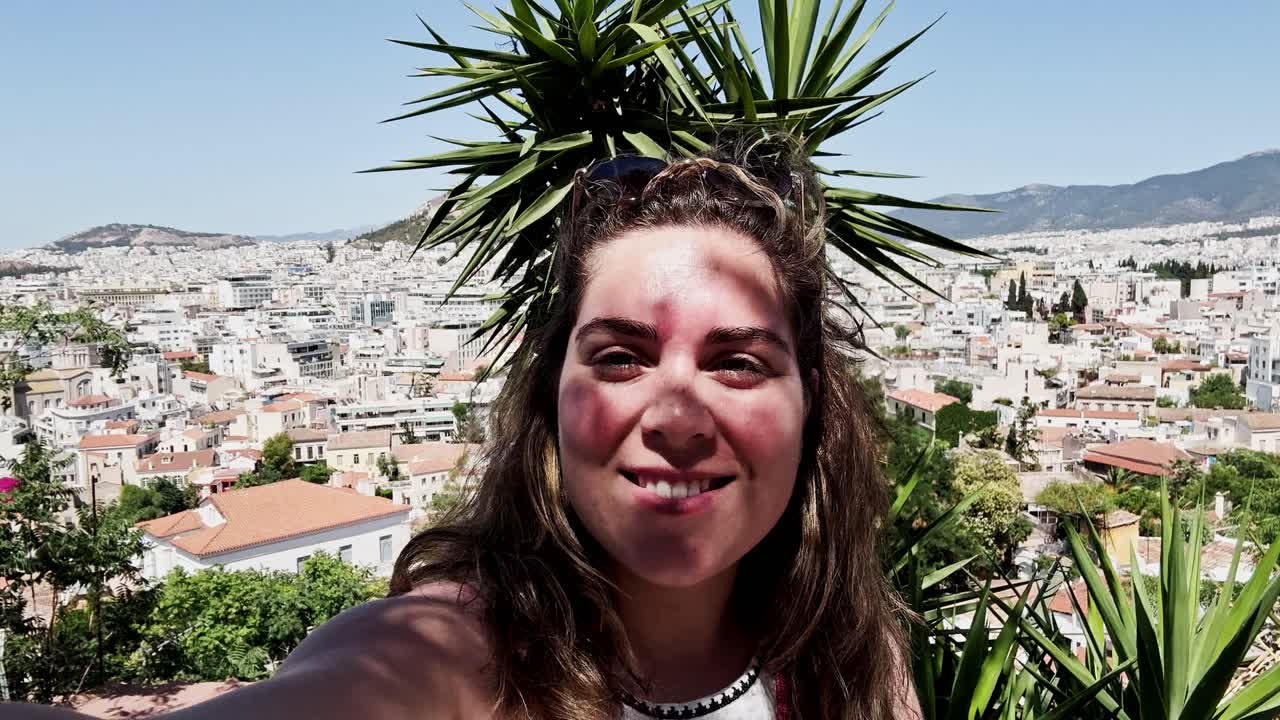 Woman Vlogging with Athens Cityscape and Palm Tree
