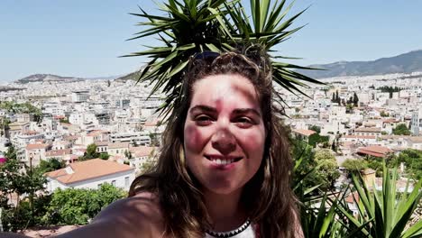 woman vlogging with athens cityscape and palm tree