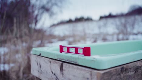 A-Man-is-Using-a-Level-for-the-Construction-of-DIY-Hot-Tub---Close-Up