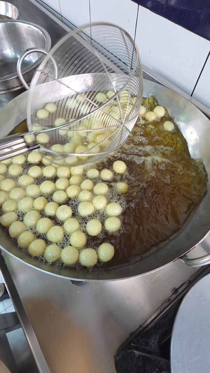 Emirati street food Luqaimat being prepared at a sweet shop in Abu Dhabi