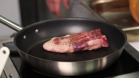 preparing seared lamb chops in a pan