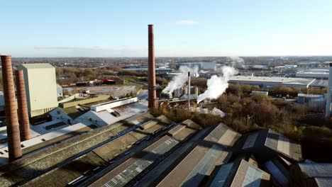 pilkington glass factory warehouse buildings aerial view across industrial chimney smokestack skyline