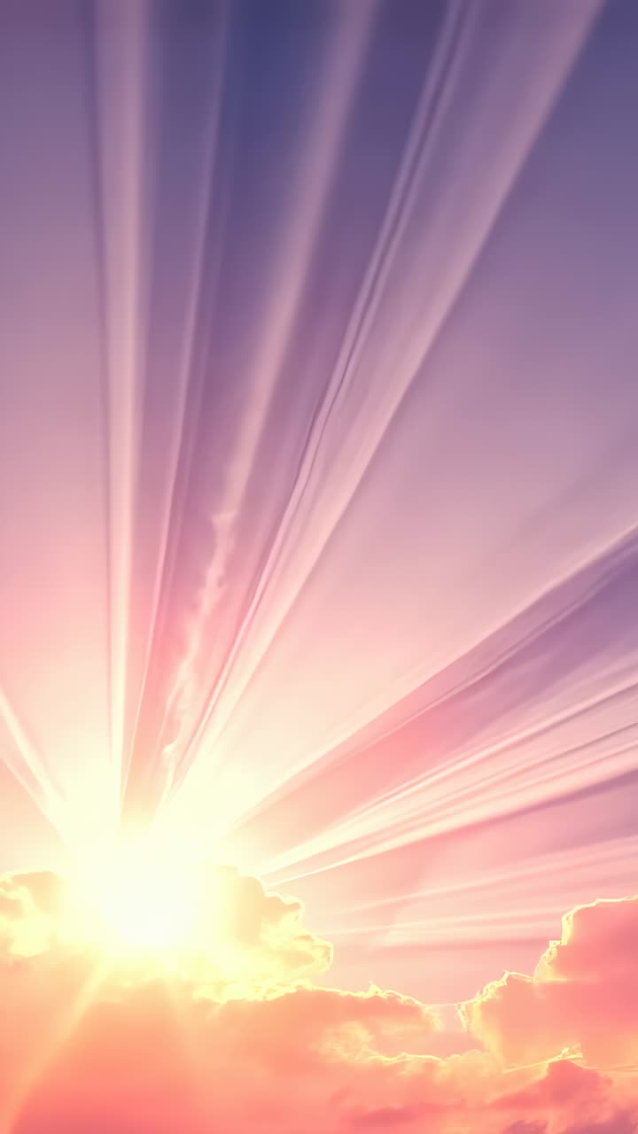 Vertical video: Slipping sun behind cumulus cloud revealing sunbeams over sunrise sky, pastel haze