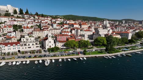 a wide view of sibenik’s coastline with its medieval buildings and clear blue waters, croatia’s charm