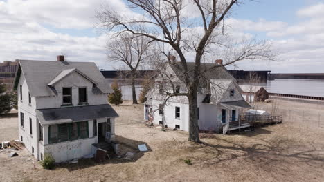 dilapidated, abandoned homes sit vacant along waterfront property at wisconsin point on lake superior