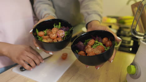 Woman-holding-salad-bowls