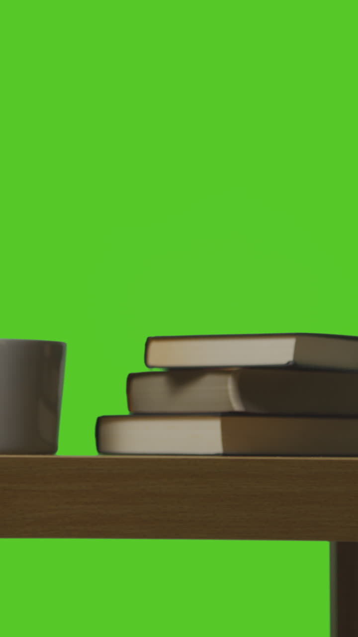 Vertical Video Of Man Picking Up Present In Gift Wrapped Box From Table Shot Against Green Screen