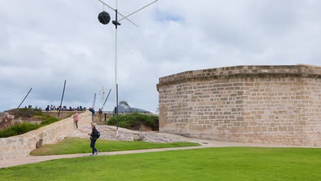the round house, western australia’s oldest public building, in fremantle.the footage shows visitors walking around this iconic limestone structure, exploring its heritage and coastal surroundings.