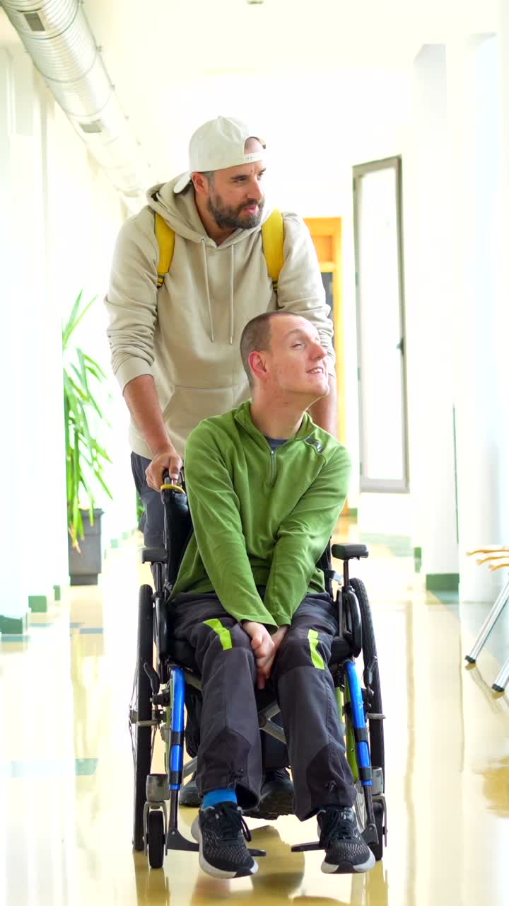 Man assisting a person in a wheelchair