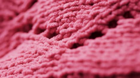 micro video of close up of pink wooly crochet fabric with copy space