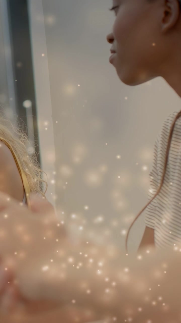 Video verticale: Donna con top a righe che si china verso la toeletta dopo aver controllato i glitter sul viso con un tocco