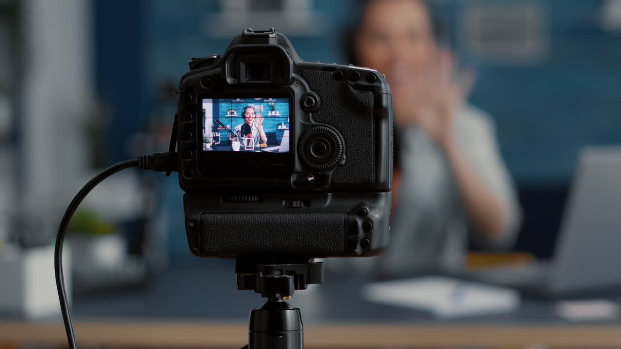 Modern camera filming influencer talking to audience
