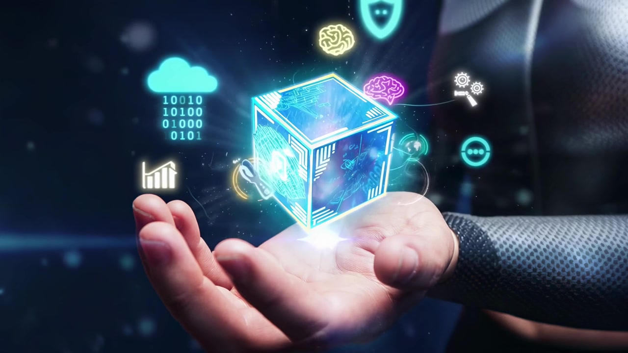 Hand Holding Glowing Digital Cube with Floating Technology Icons