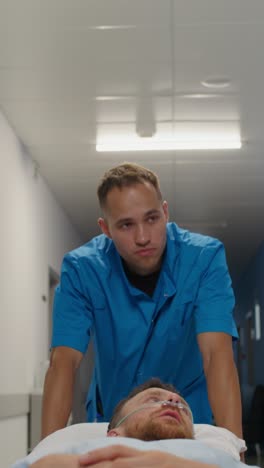 nurse assisting patient in hospital corridor