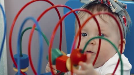 child plays with a multi-colored toy 16