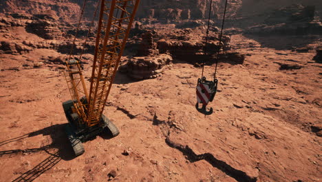 una grúa de construcción amarilla en un cañón del desierto
