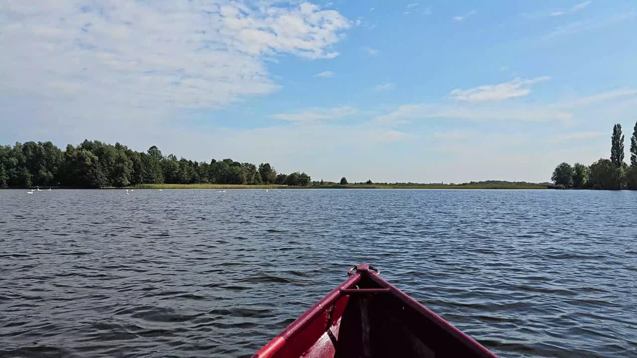 This footage shows a wide-open lake from the front side of a boat.
