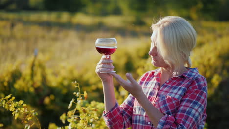 woman tasting wine in vineyard