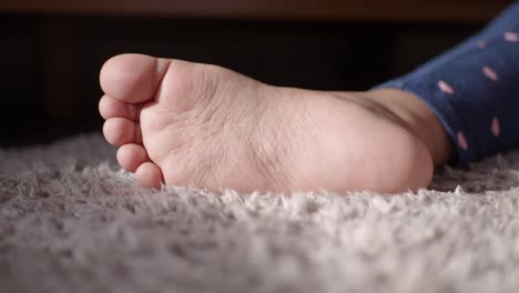 child's foot on carpet