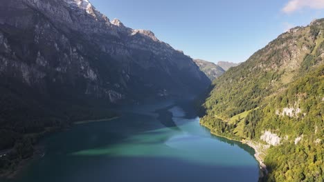 Autumnal-hues-drape-Glarus-Valley's-serene-Alpine-Lake